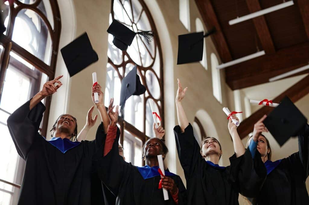 Young People Throwing Graduation Caps